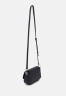 Tommy Hilfiger EMBLEM FLAP CROSSOVER Across body bag space blue EMBLEM FLAP CROSSOVER Сумка через плечо космический синий